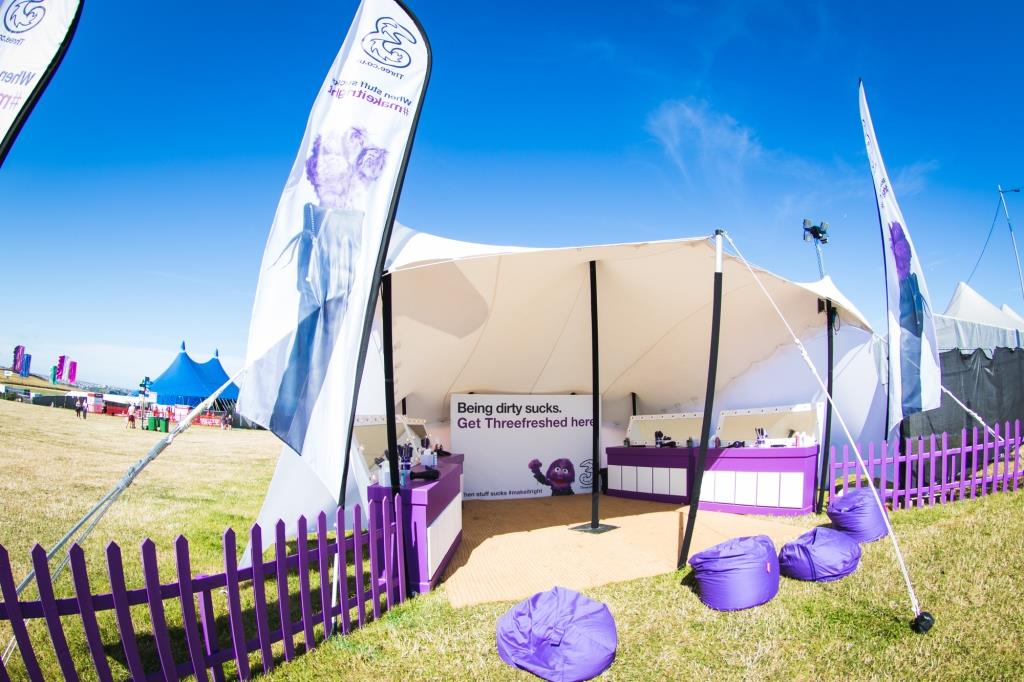 Compact white stretch canopy set up as a festival brand activation