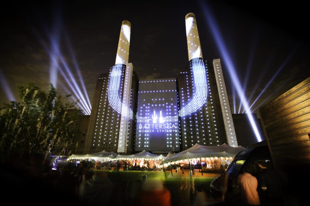 Linked stretch canopies lit by projections for a night launch event