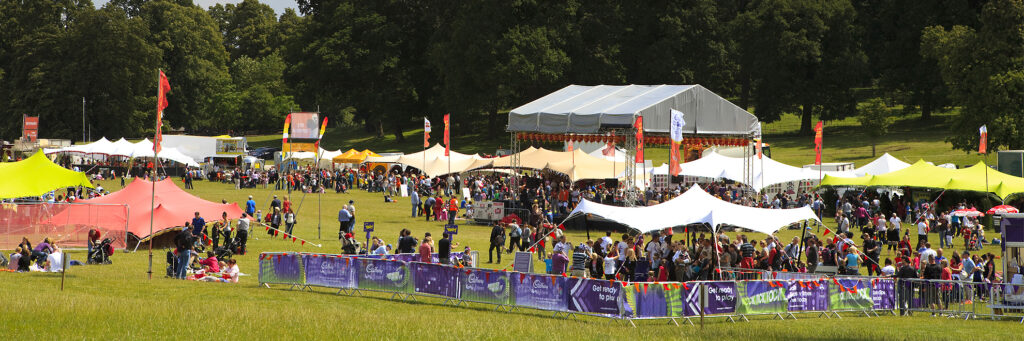 A stretch tent over a festival food and bar area