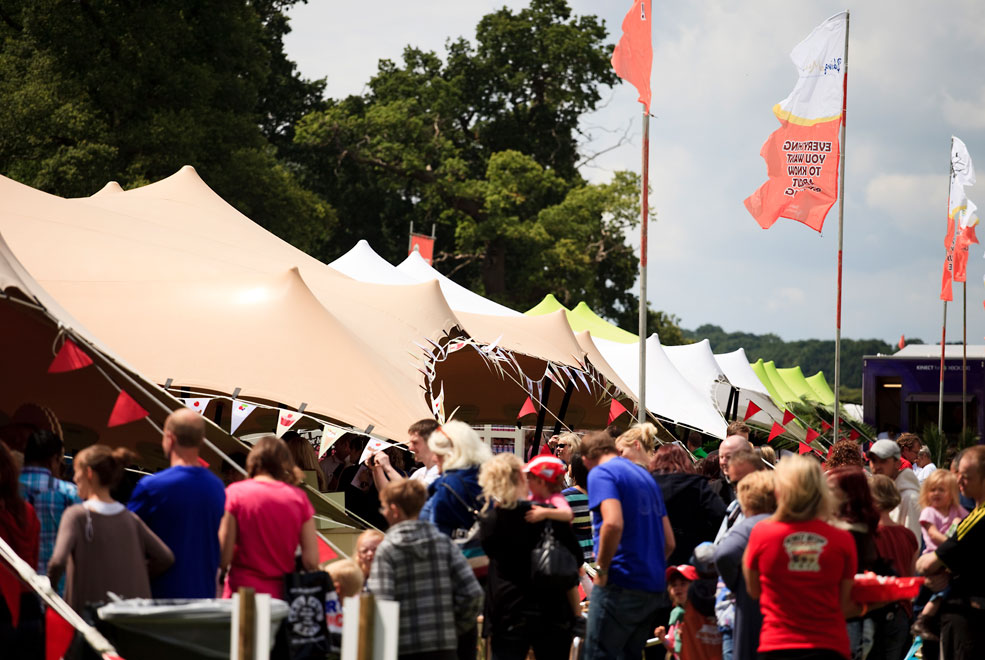 A large stretch canvas structure on a greenfield festival site