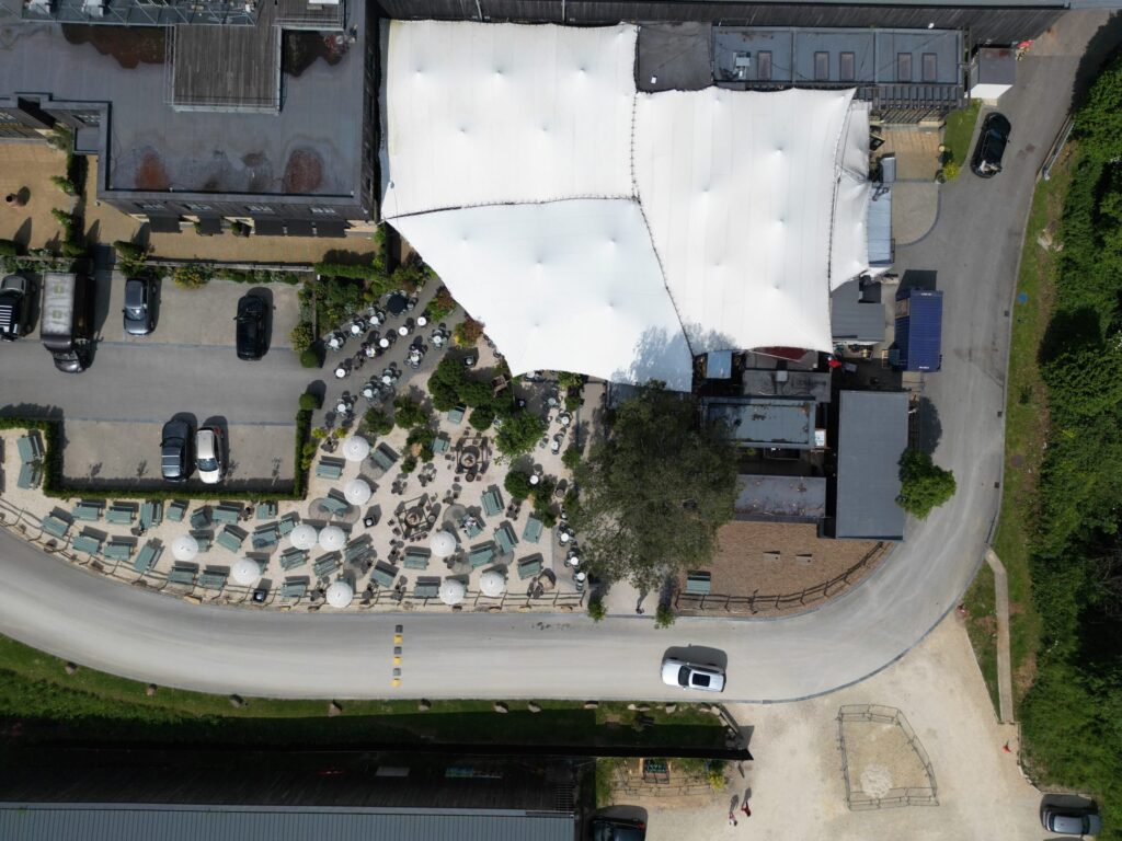 Aerial view of linked stretch canopies over an outdoor hospitality venue